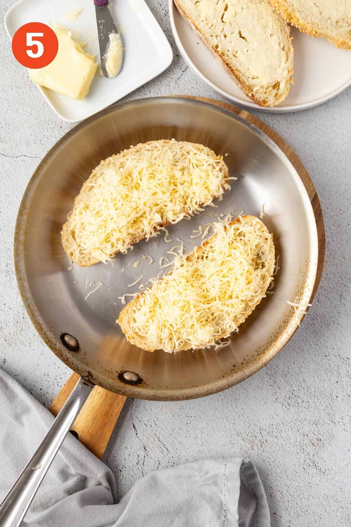 Slices of bread in a skillet with cheese on top.