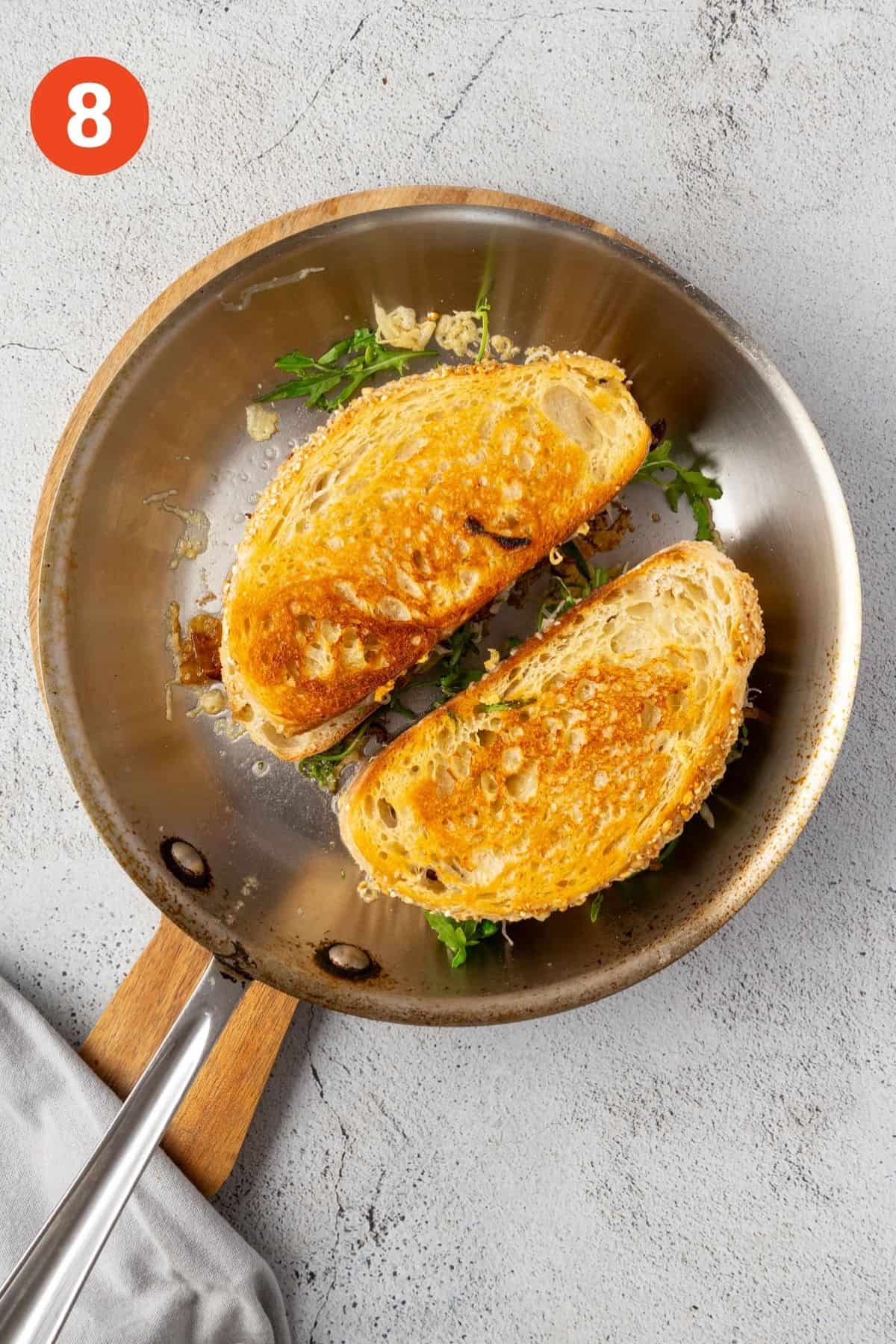 French onion grilled cheese sandwiches flipped over to show toasted side.
