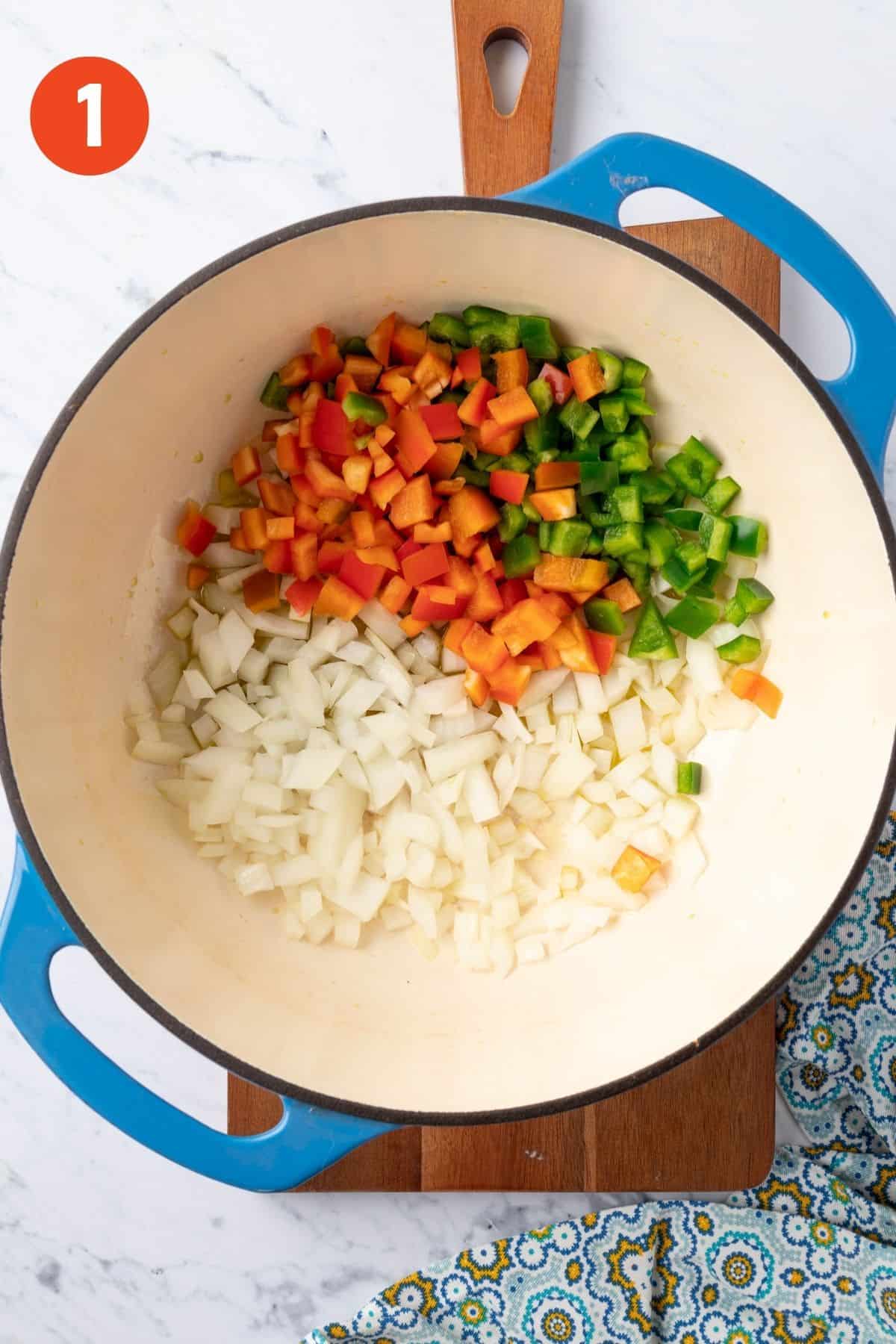 Onion and bell pepper in the pot to cook.