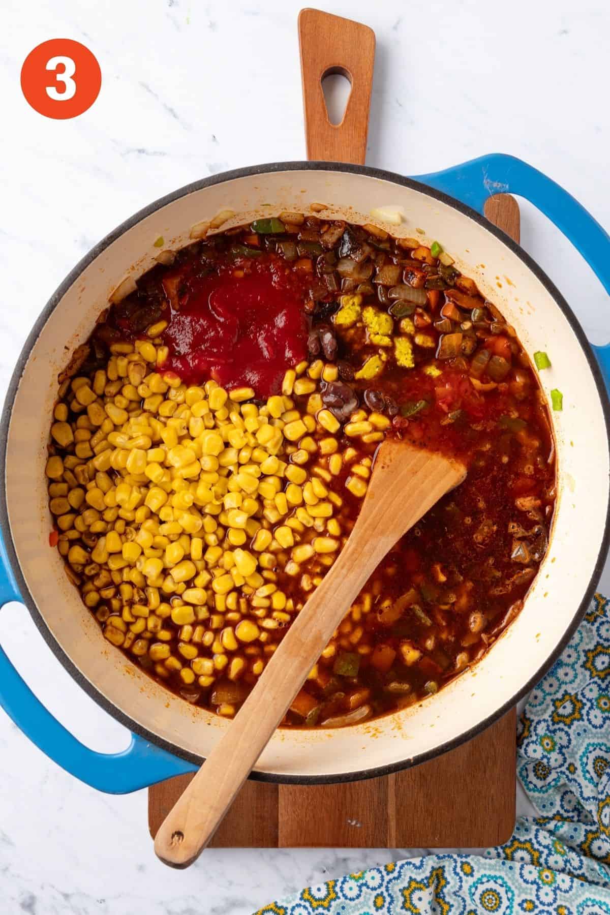 Corn, beans, and tomato paste added to the pot.