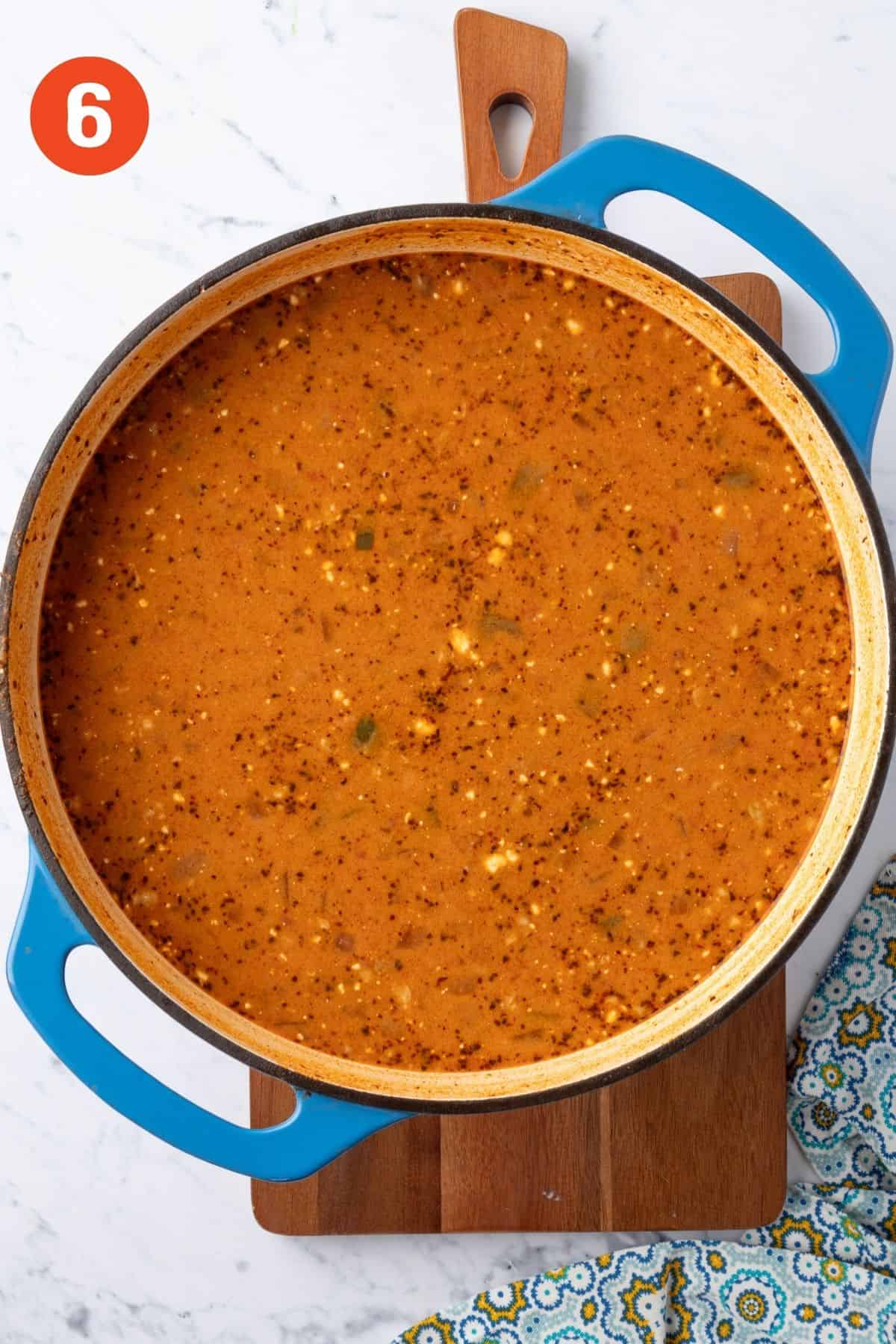 Cream cheese added to the pot of soup.
