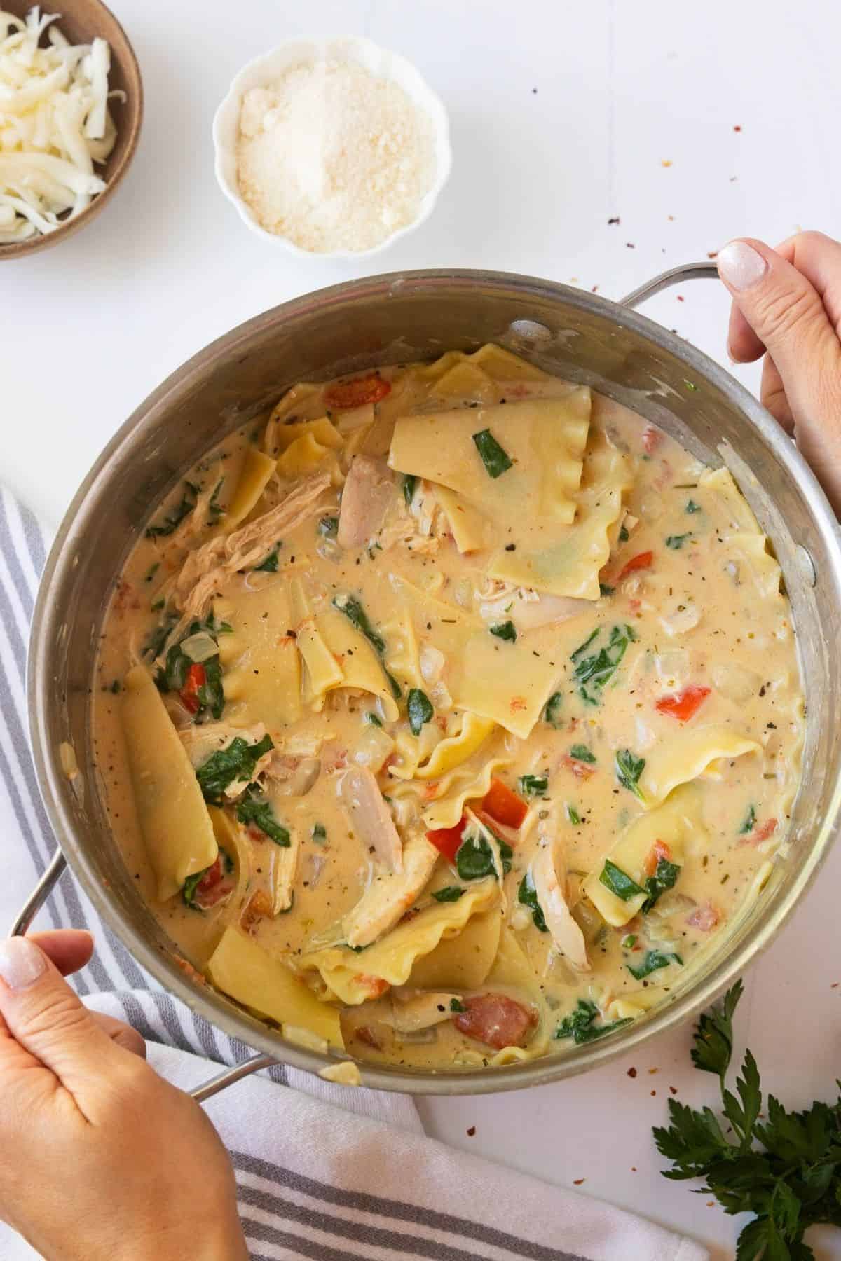A pot of white lasagna chicken soup.