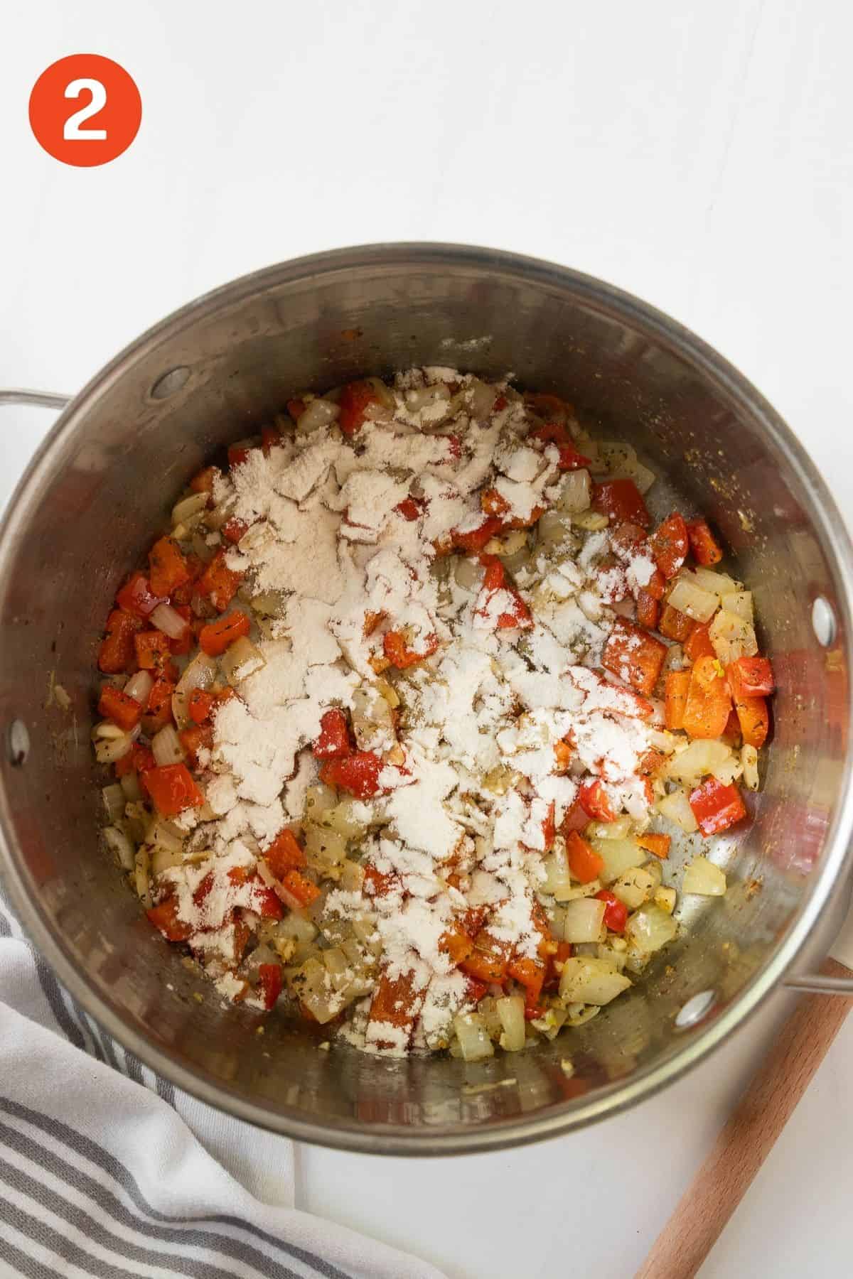 Flour added to the pot with the cooked vegetables.