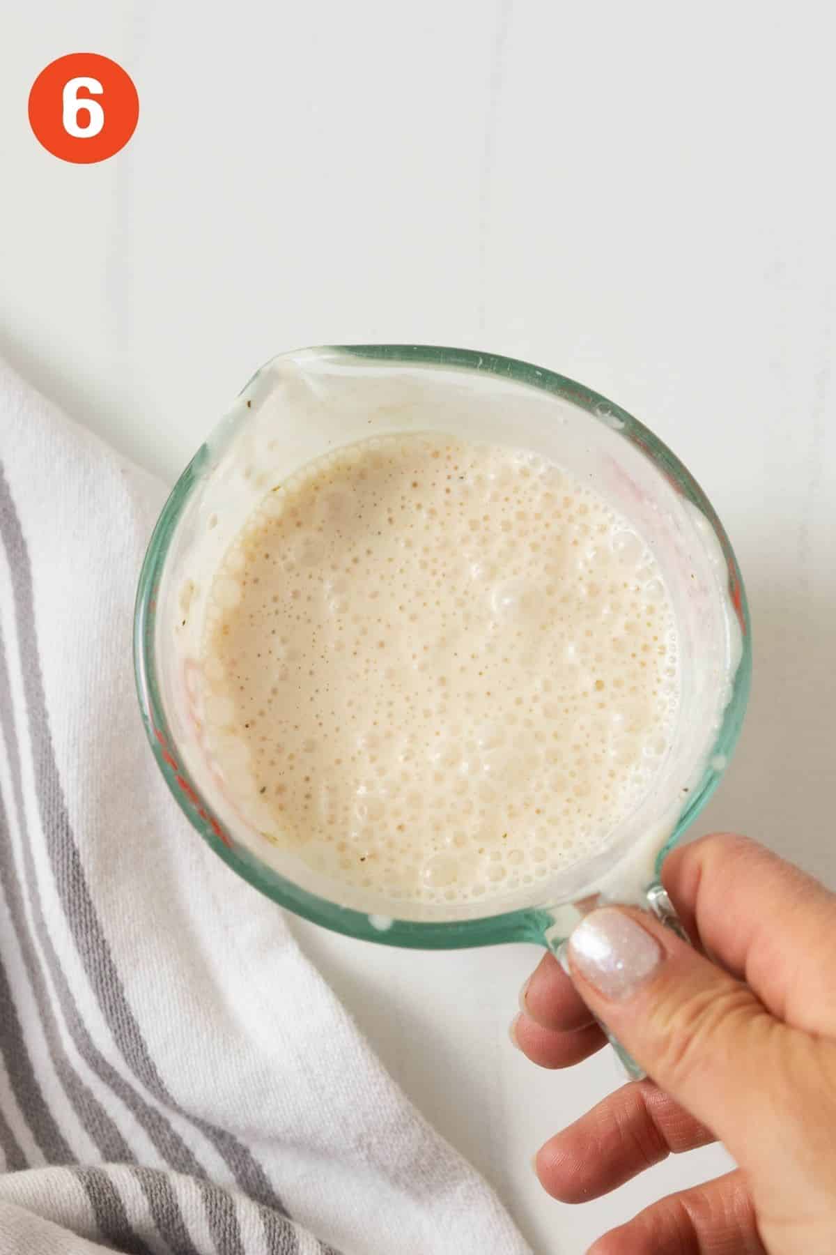 Cream cheese mixture in a the measuring cup after mixed smooth.