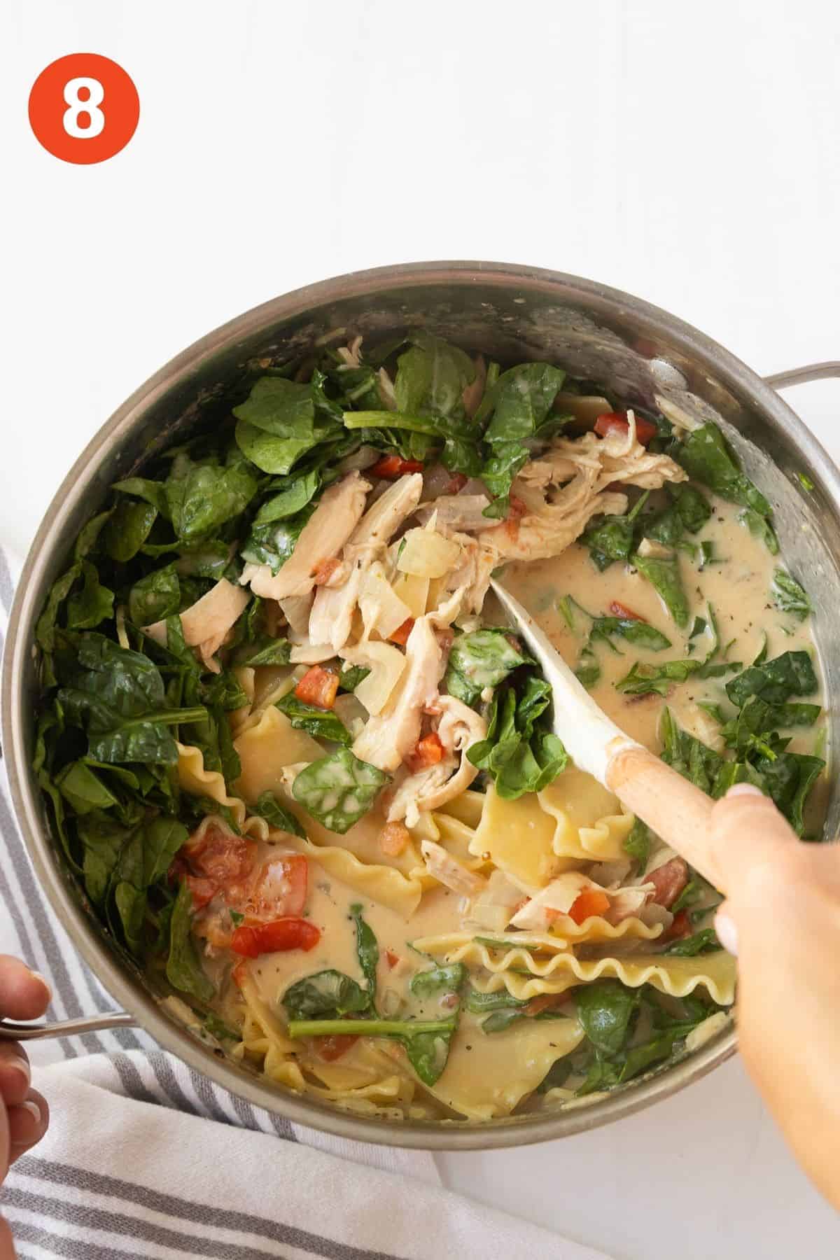 Spinach added to the white chicken lasagna soup.