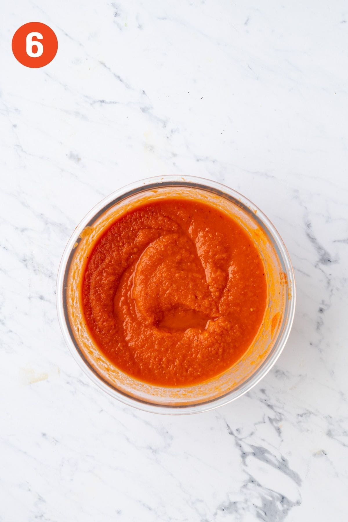 Cold tomato soup after chilling in a glass bowl.