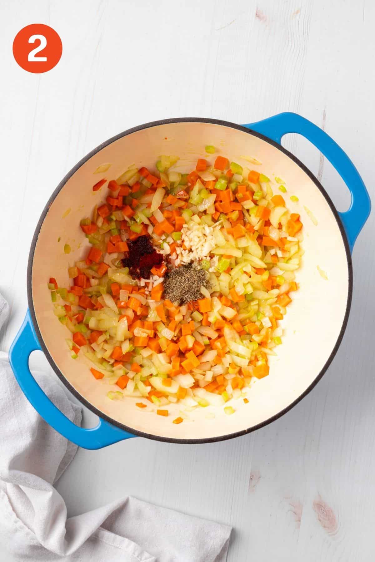 Garlic and seasonings added to the cooked vegetables.