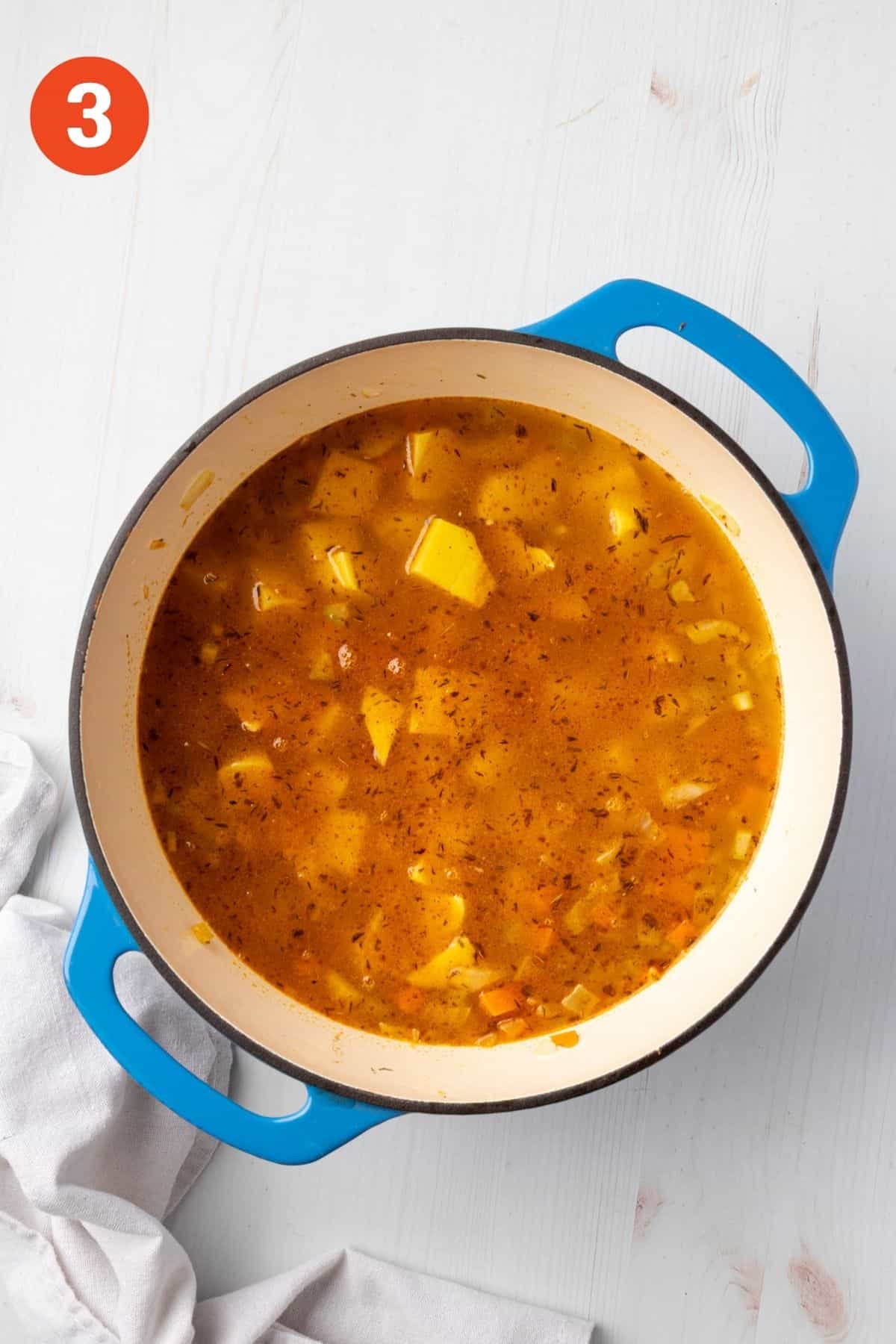 Broth and potatoes added to the pot.