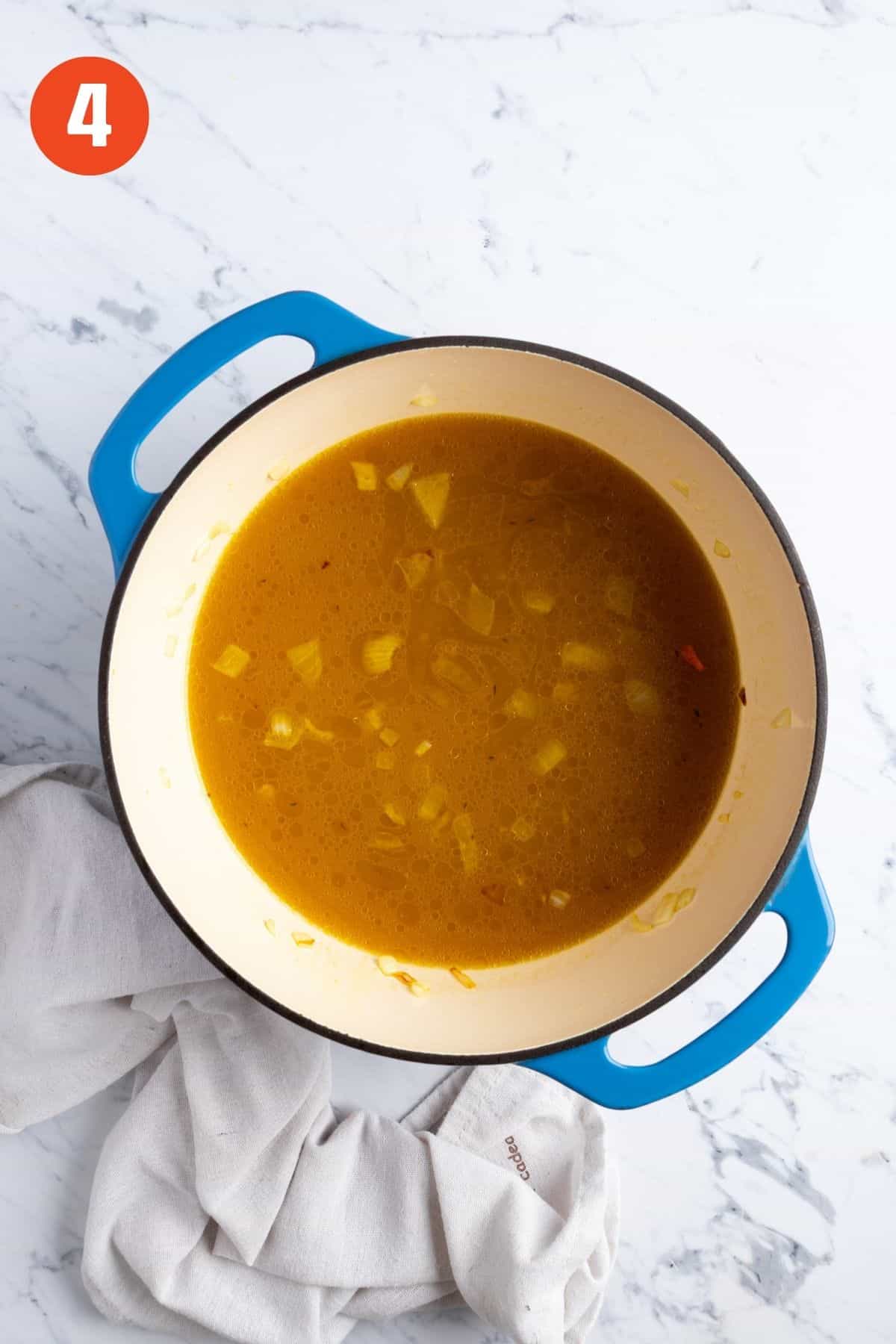 Broth added to the vegetables to cook.
