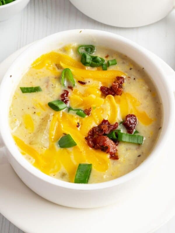 Creamy potato corn chowder garnished with green onions and bacon bits.
