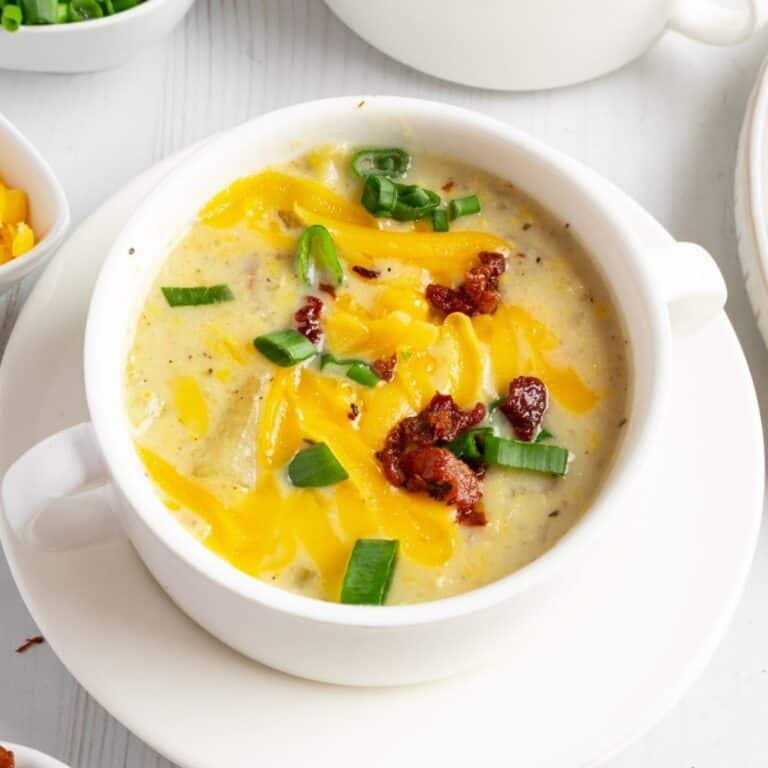 Creamy potato corn chowder garnished with green onions and bacon bits.