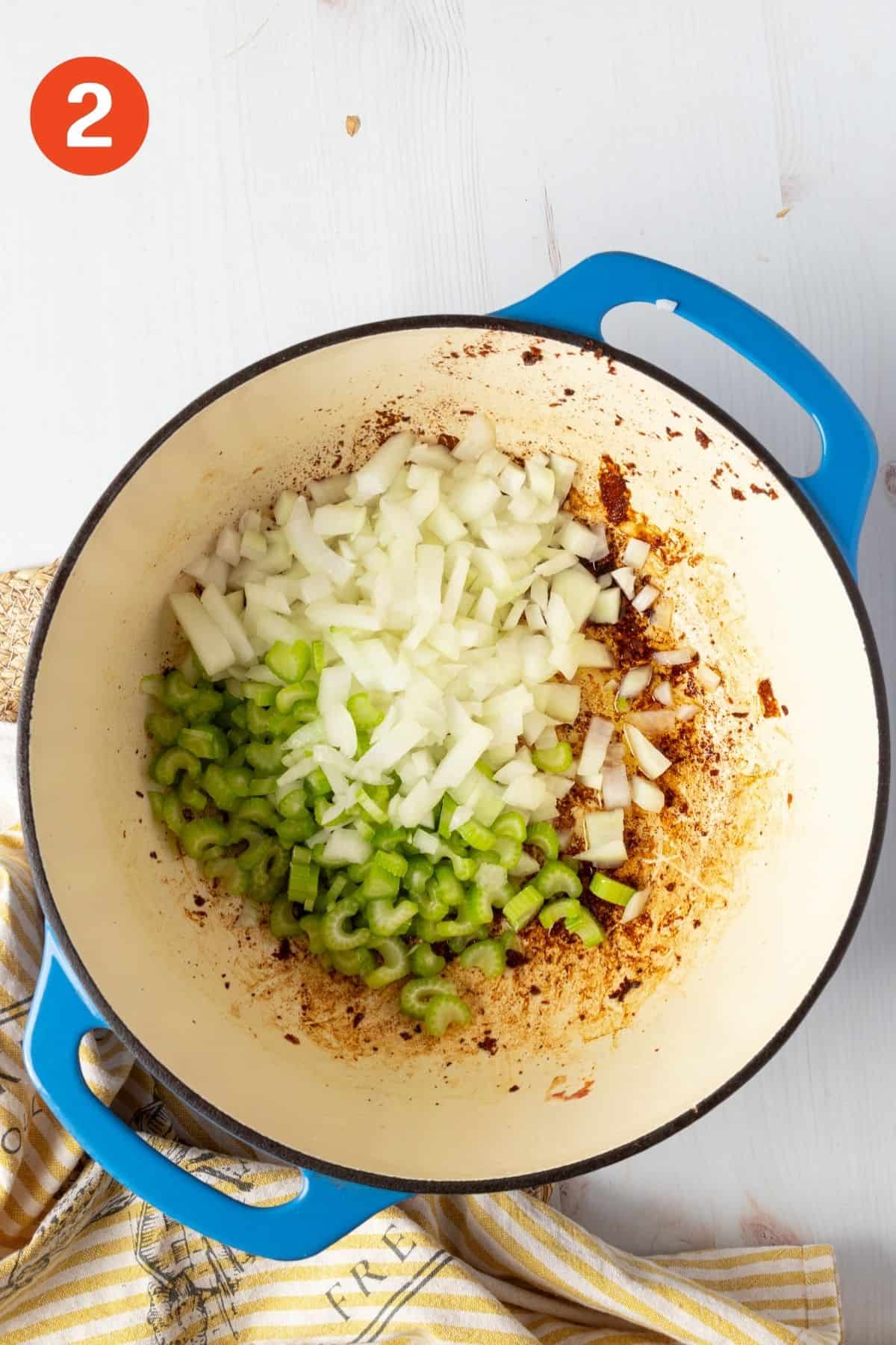 Chopped onions and celery in a pot for potato corn chowder.