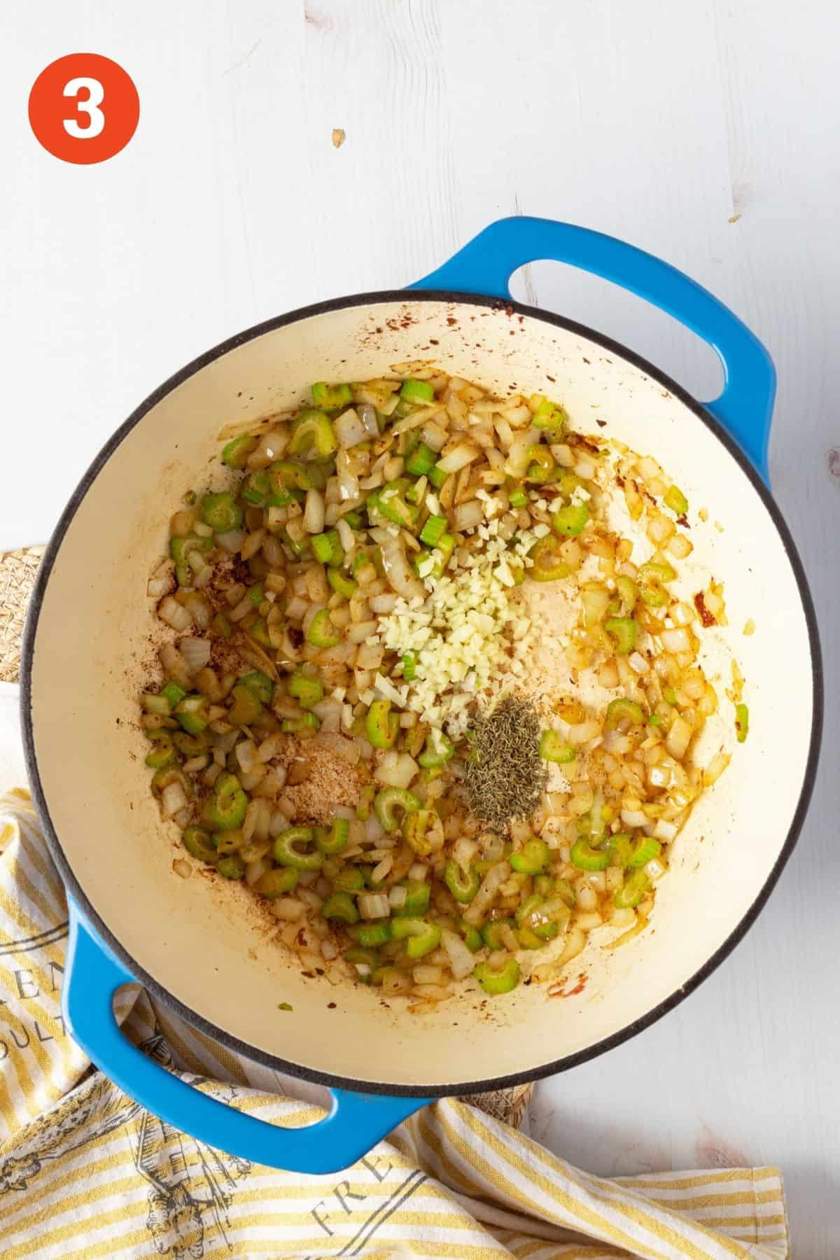 Sautéed onions, celery, and garlic add to a blue pot for chowder base.