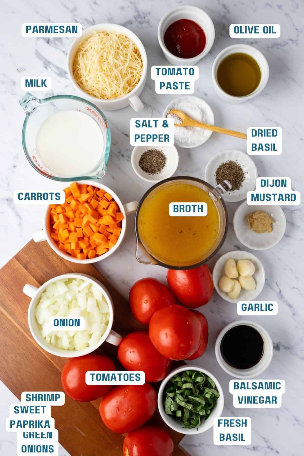 Ingredients to make roasted tomato basil soup on a table.