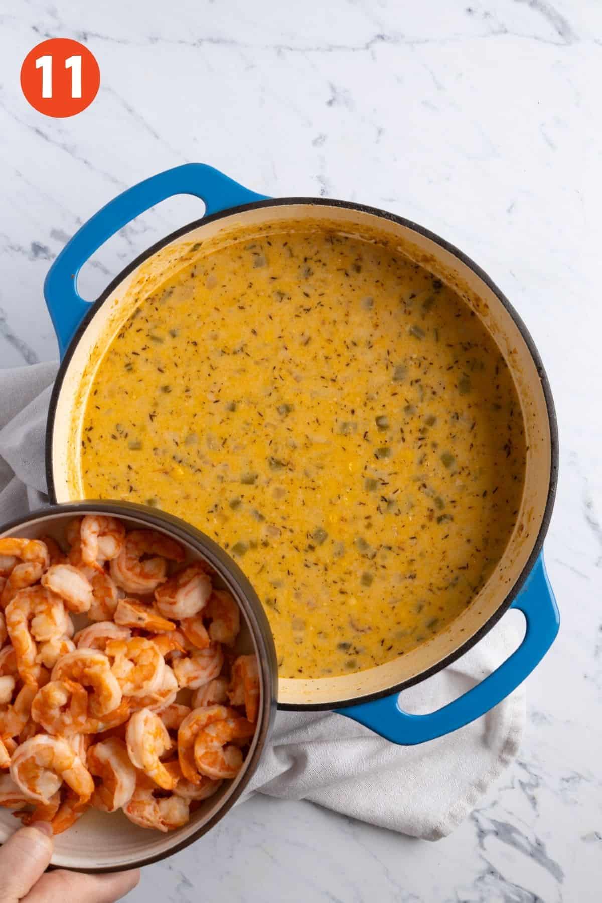 Shrimp in a bowl about to go into the pot of soup.