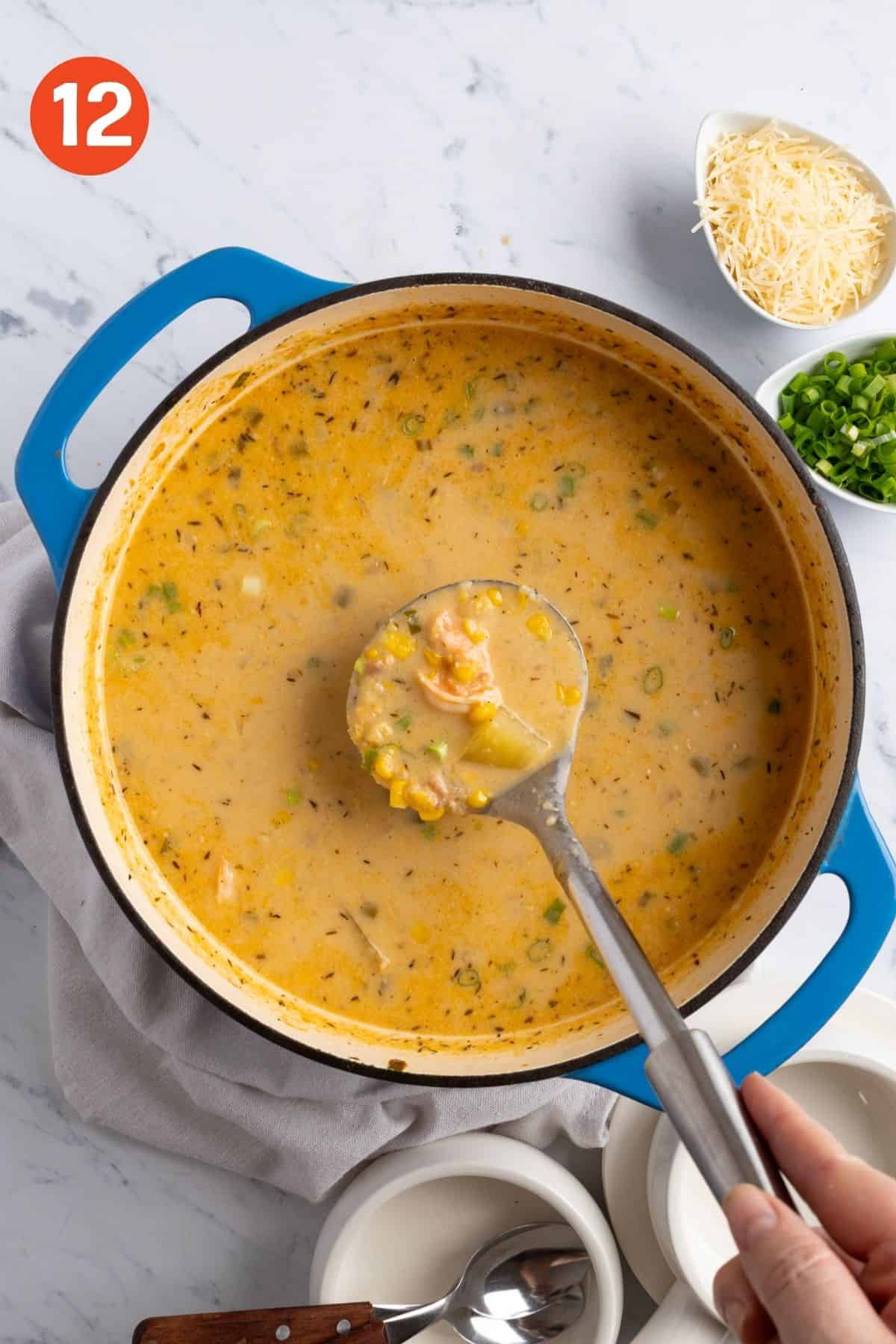 Finished soup with a ladle lifting up a serving.