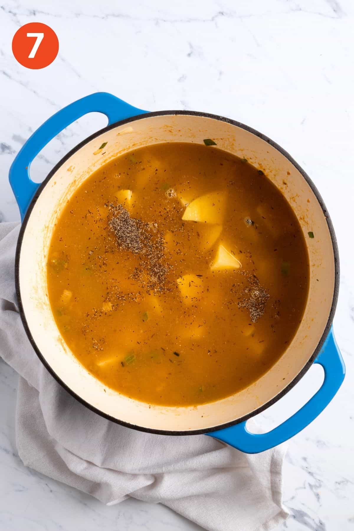 Potatoes and broth added to the pot.