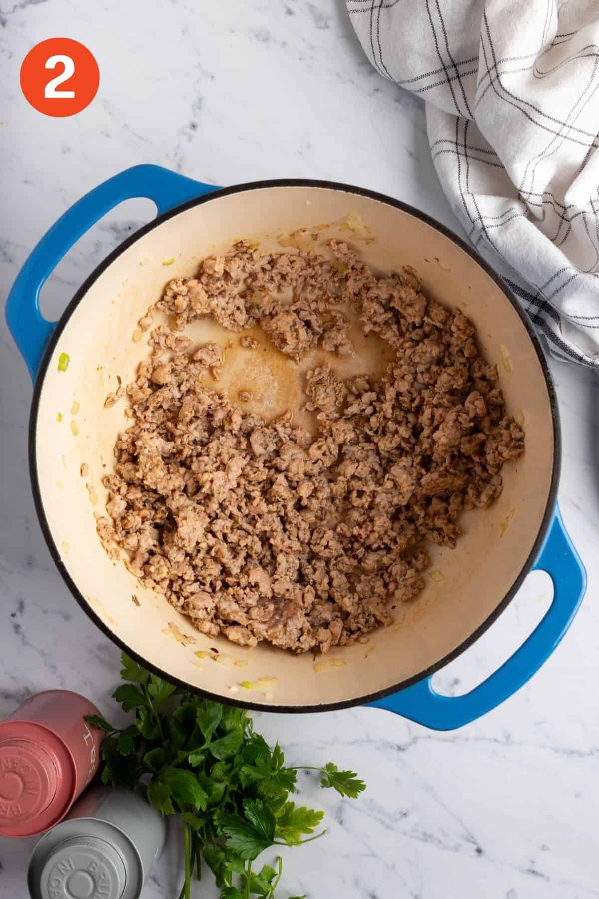 Italian sausage browning in the pot.